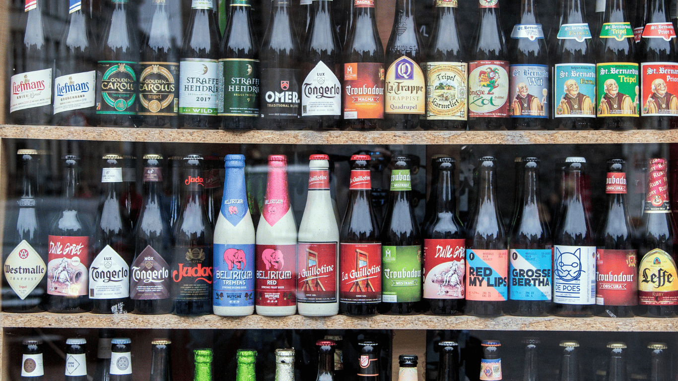 Shelves with beer bottles in a store.