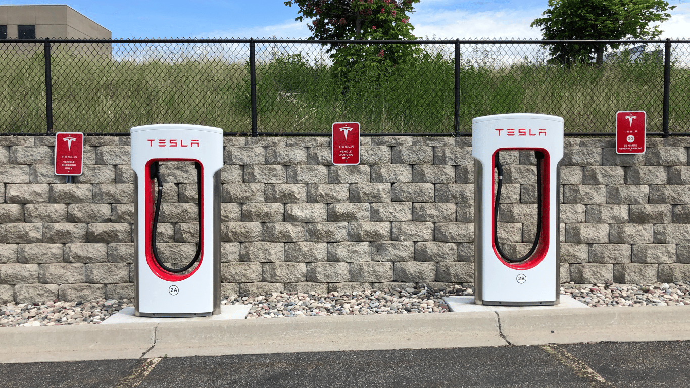 Tesla Superchargers in a parking lot.